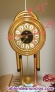 Reloj de pared metal dorado pendulo